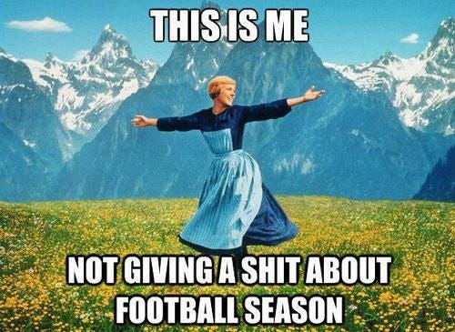 This may contain: a woman in a blue dress standing on top of a field with her arms outstretched