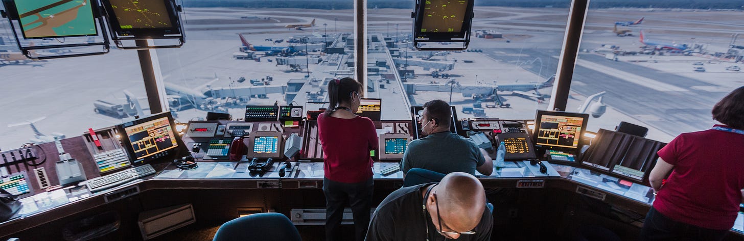 Air traffic controllers working in a control tower overlooking a busy runway, symbolizing the exhausted workers keeping America’s skies safe amid the ongoing government shutdown. Air traffic controllers working in a control tower overlooking a busy runway, symbolizing the exhausted workers keeping America’s skies safe amid the ongoing government shutdown.