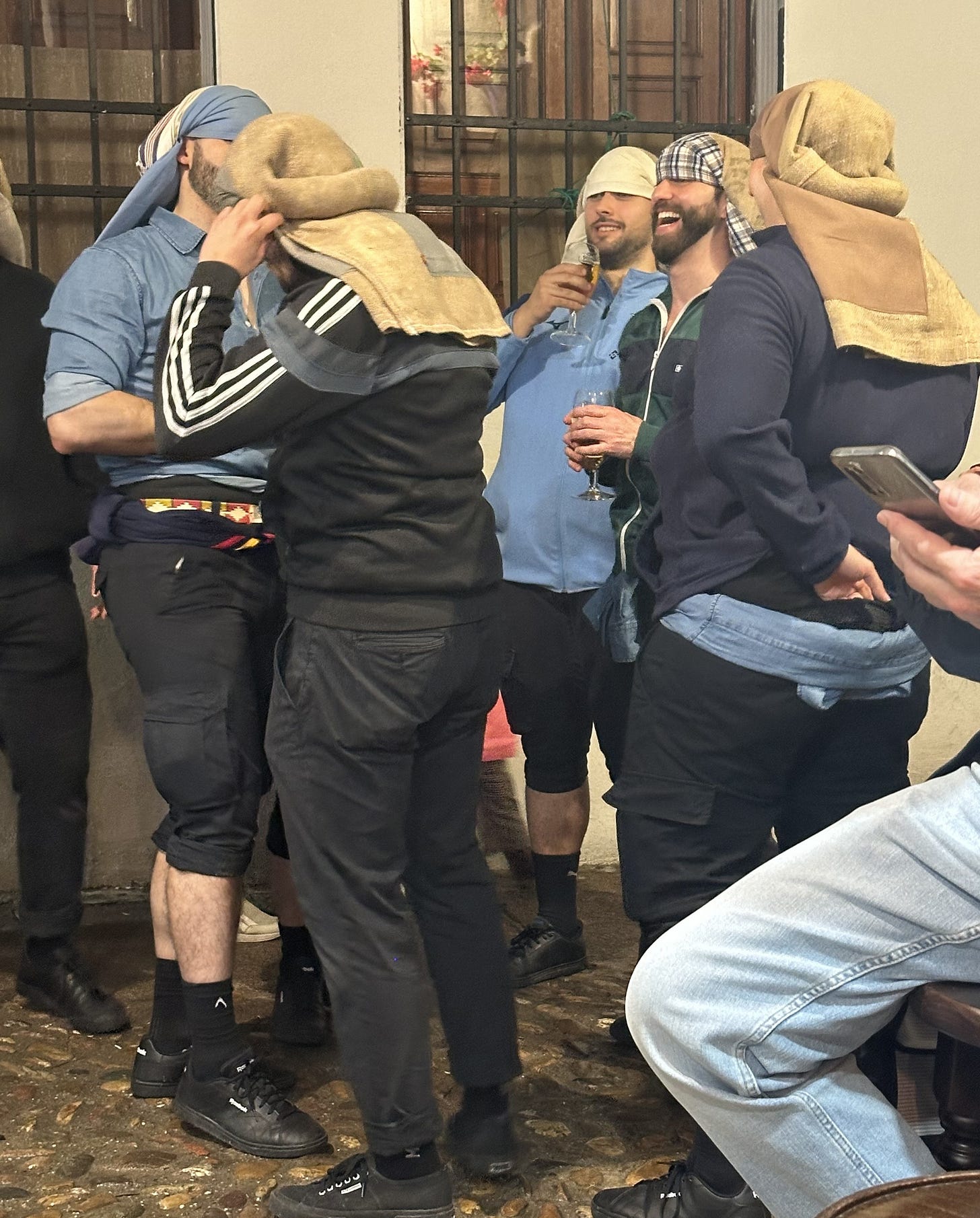 Men taking a break during easter processions Men taking a break during easter processions