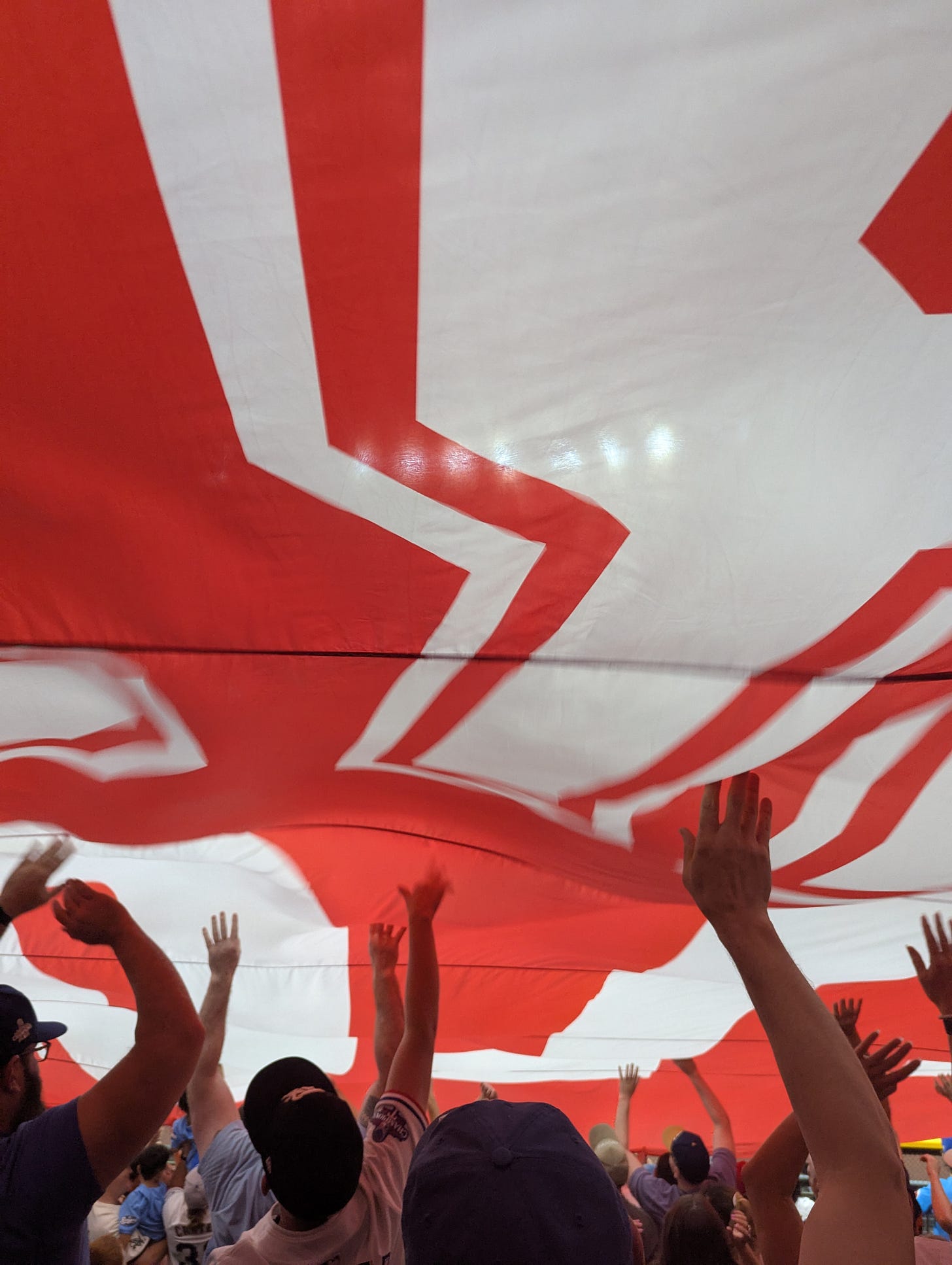 Looking up into a large red and white banner overhead. Looking up into a large red and white banner overhead.