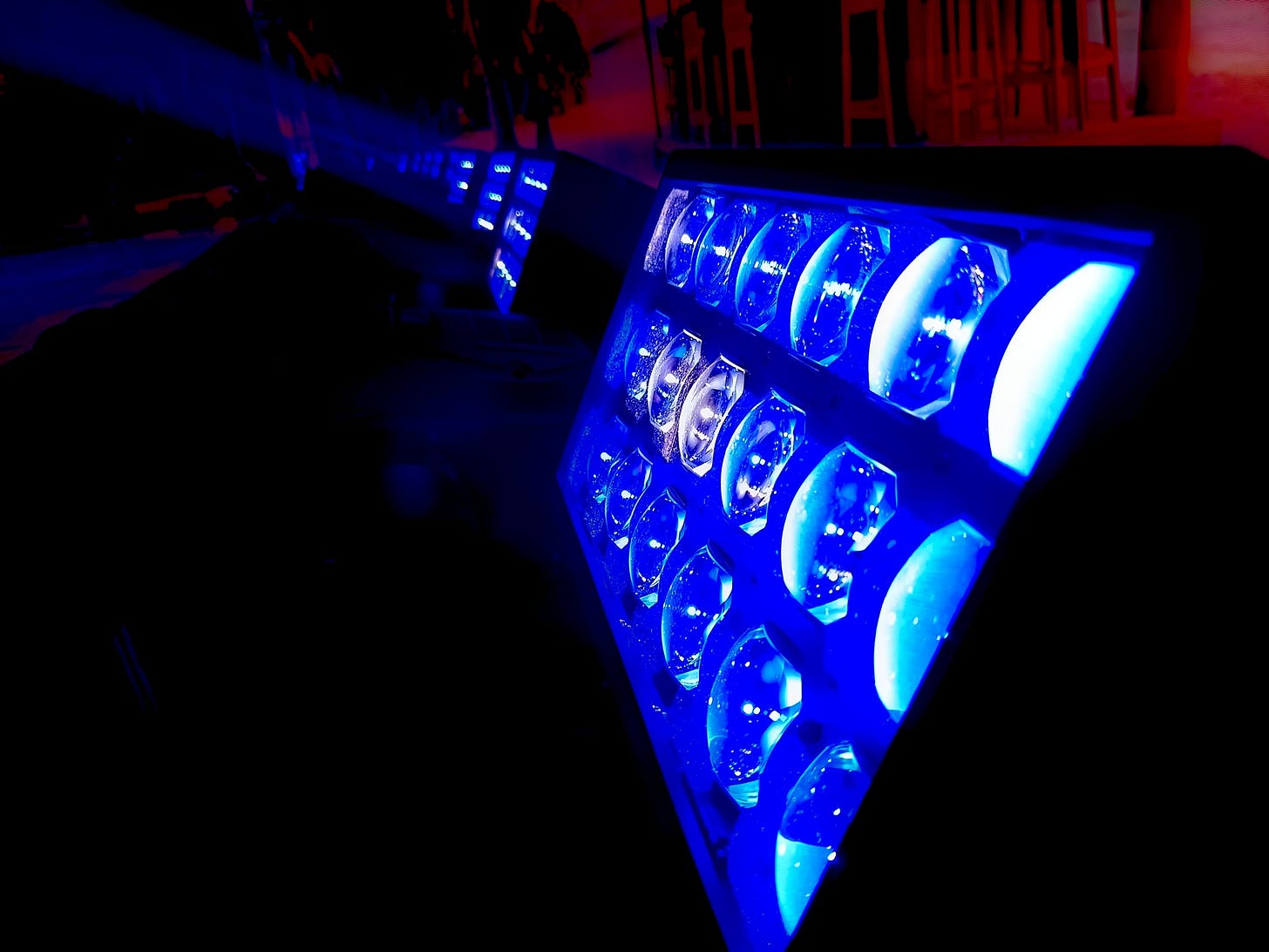 Stage lighting fixtures in blue tones prepared for live event broadcast, ensuring balanced illumination for cameras and audience