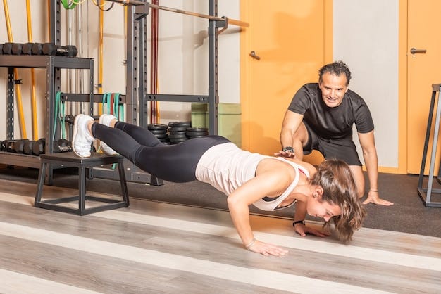 Sportswoman doing push ups with her feet on box with trainer in the gym. Concept of exercises in gym. Sportswoman doing push ups with her feet on box with trainer in the gym. Concept of exercises in gym.