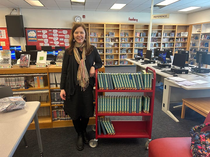 Shana Youngdahl with a sign that says "Welcome Shana Youngdahl" painted with flames, tiny gnomes ontop of the book A Catalog of Burnt Objects by Shana Youngdahl, Shana Youngdahl with a cart of books to sign for students, Shana Youngdahl with the library and a teacher from Centennial High