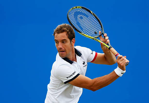 Richard Gasquet of France plays a backhand in his men's singles second round match against Milos Raonic of Canada during day three of the Aegon...