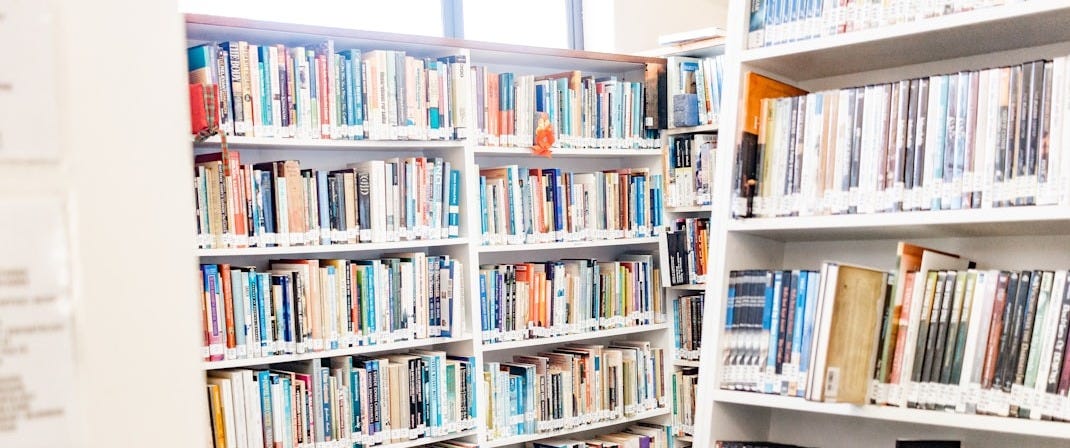white wooden book shelves with books white wooden book shelves with books