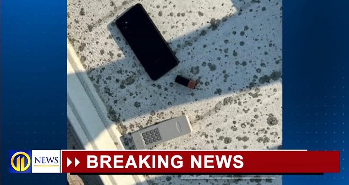 A black smartphone, a small USB drive, and an old-style mobile phone lying on a textured surface, indicating a potential newsworthy event. A black smartphone, a small USB drive, and an old-style mobile phone lying on a textured surface, indicating a potential newsworthy event.