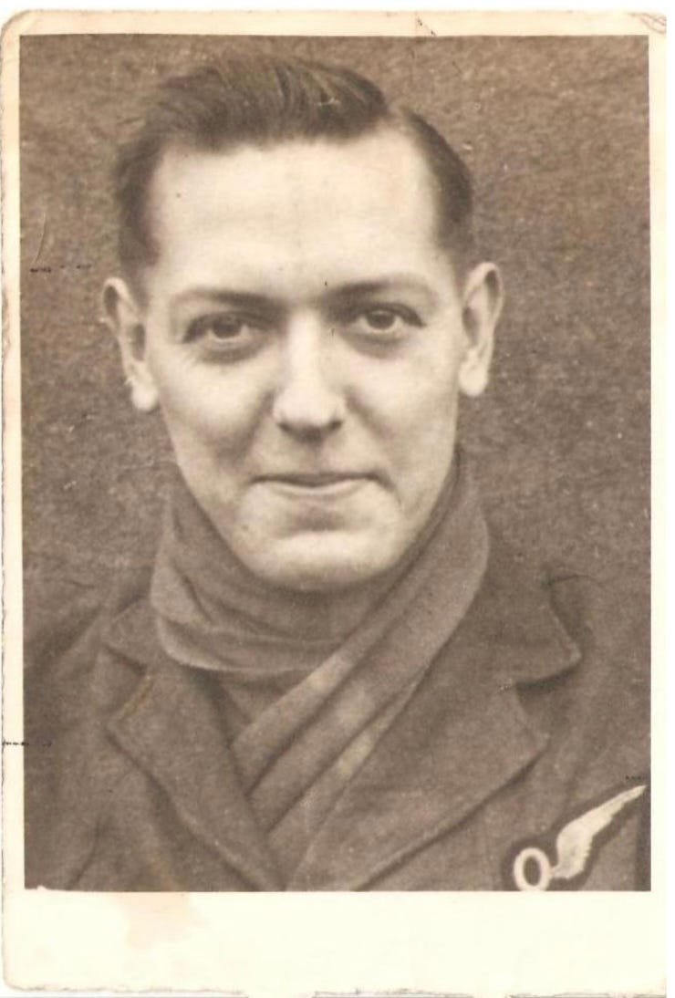 A black and white photo of a white man with dark hair and eyes, pronounced cheekbones, sizeable ears and a smirk on his face wearing an RAF WWII uniform.