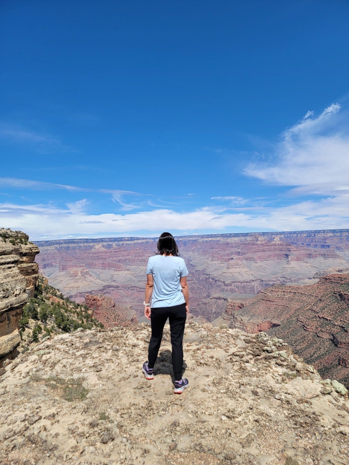Shannon standing on the edge of the Grand Canyon South Rim