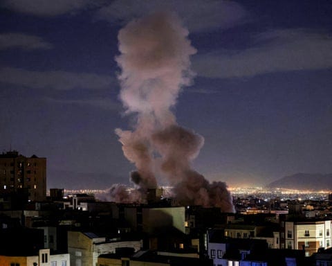 A smoke plume rises following a missile strike on a building in Tehran.
