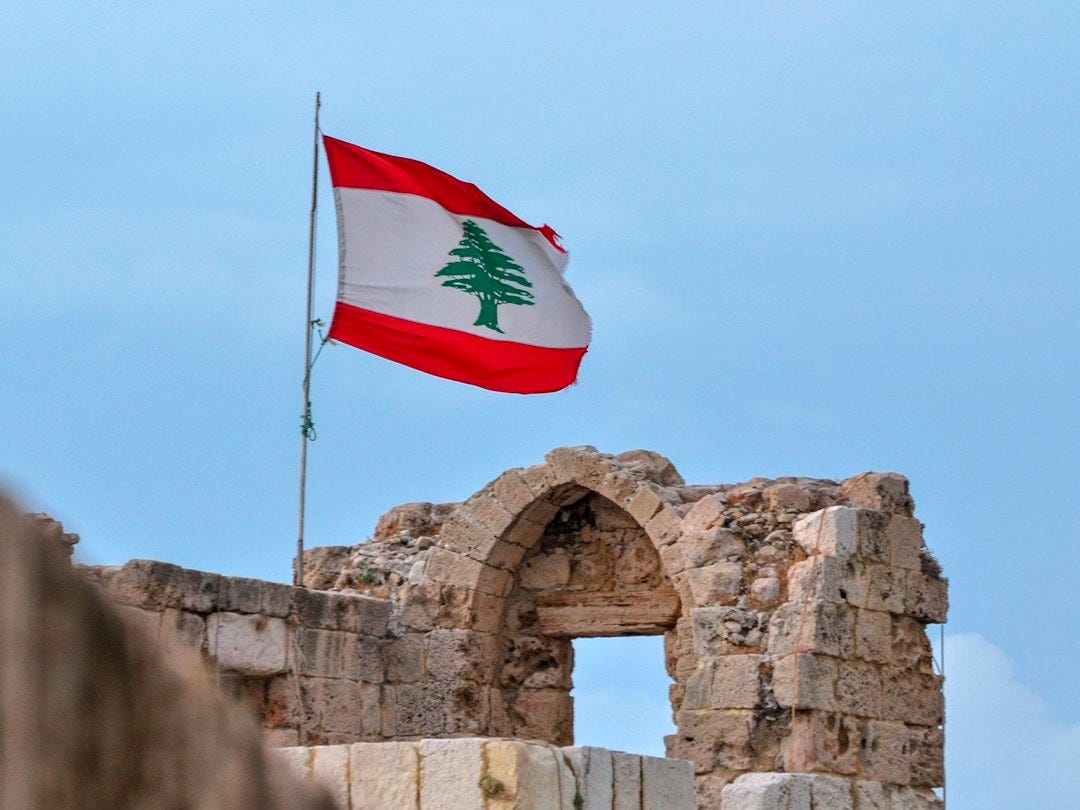 a flag flying on top of a stone structure a flag flying on top of a stone structure