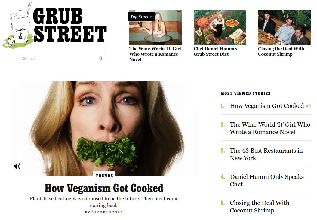 Screenshot of the Grub Street website homepage. At the top left is the Grub Street logo above a search bar. Across the top are featured story thumbnails, including articles about a wine writer, chef Daniel Humm, and a story titled “Closing the Deal With Coconut Shrimp.”

The main feature image dominates the center: a close-up of a blonde woman staring directly at the camera with blue eyes, her mouth filled with fresh green sprouts or microgreens, as if gagged by them. Beneath the image is the headline “How Veganism Got Cooked,” labeled as a Trends article, with the subheading “Plant-based eating was supposed to be the future. Then meat came roaring back,” by Rachel Sugar.

On the right side is a “Most Viewed Stories” list, ranking the same veganism article first, followed by restaurant and chef-related pieces.