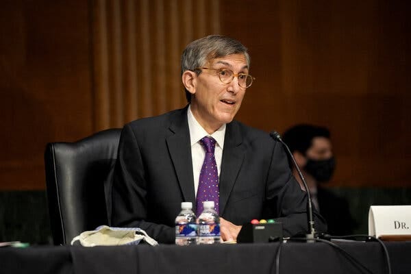 Dr. Peter Marks, wearing a dark suit and purple tie, speaks into a microphone while seated. Dr. Peter Marks, wearing a dark suit and purple tie, speaks into a microphone while seated.