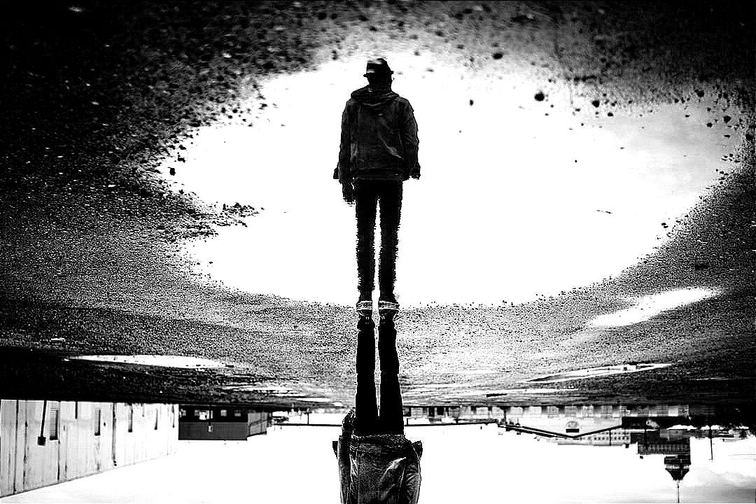 man's reflection on body of water photography man's reflection on body of water photography