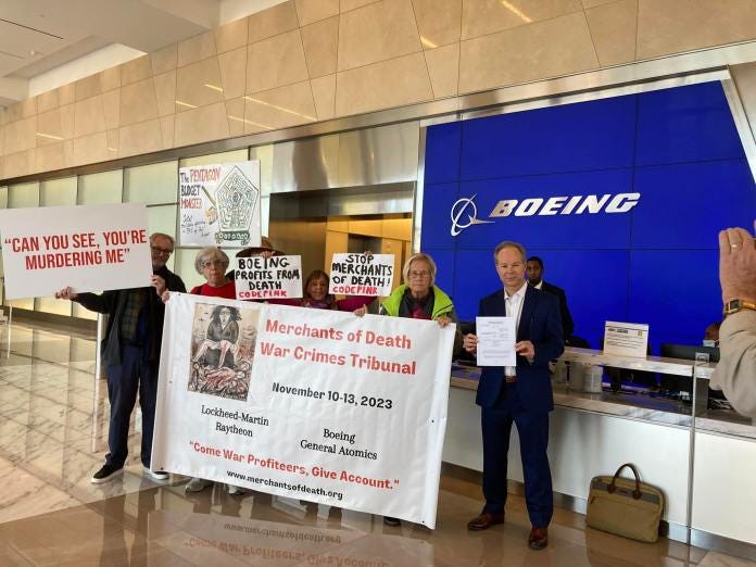 A group of people holding signs

Description automatically generated
