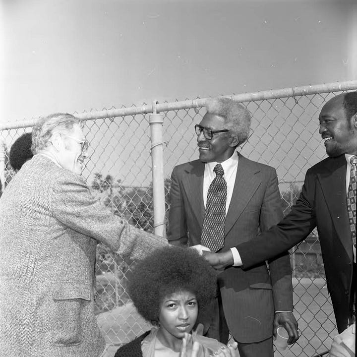 Left to right: Bayard Rustin (4th from left) poses with Los Angeles Chapter A. Philip Randolph Institute President Samuel McNeal, Jr. (left), LA County AFL-CIO Executive Secretary Sigmund Arywitz (3rd from left), Tom Bradley (5th from left), A. Philip Randal Institute Field Director Lois Felder (2nd from right), Arnett Hartsfield (right) and others during an event to honor Mr. Rustin at the home of singer Ray Charles, Los Angeles, 1973; Bayard Rustin talking with Tom Bradley, Los Angeles, 1973; Bayard Rustin standing between Sigmund Arywitz and Samuel McNeal, Jr., Los Angeles, 1973; Bayard Rustin, Gwen Green, and Ken Orduna standing together, Los Angeles, 1973. All photos by Guy Crowder ©Tom and Ethel Bradley Center