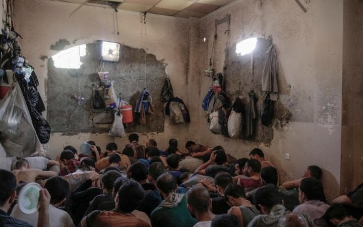 Associated Press reporters visiting the facility saw more than 100 prisoners packed into a dark room, lined up shoulder to shoulder on the floor. Associated Press reporters visiting the facility saw more than 100 prisoners packed into a dark room, lined up shoulder to shoulder on the floor.