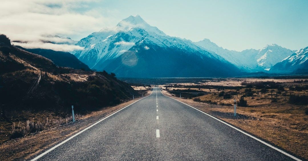 road near mountain during daytime