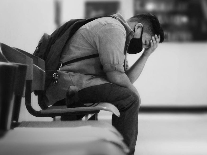 man in black jacket sitting on chair