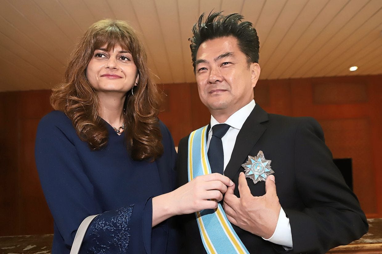 Sim Leisure Group founder and chief executive officer Datuk Sim Choo Kheng and wife Datin Silviya Georgieva showing his Datuk Setia Pangkuan Negeri medal.