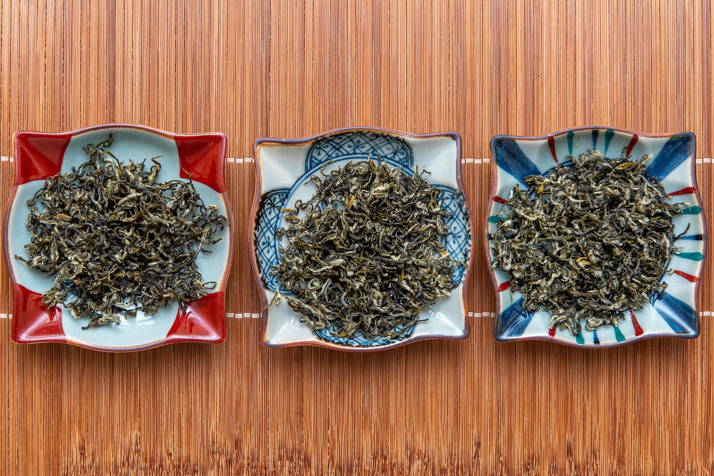 ID: Line up of three batches of bi luo chun green tea