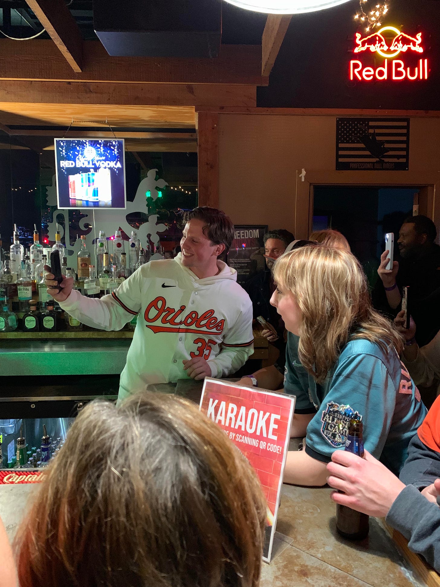 Adley takes photos with fans at a Birdland Caravan karaoke night, Jan. 31, 2025.