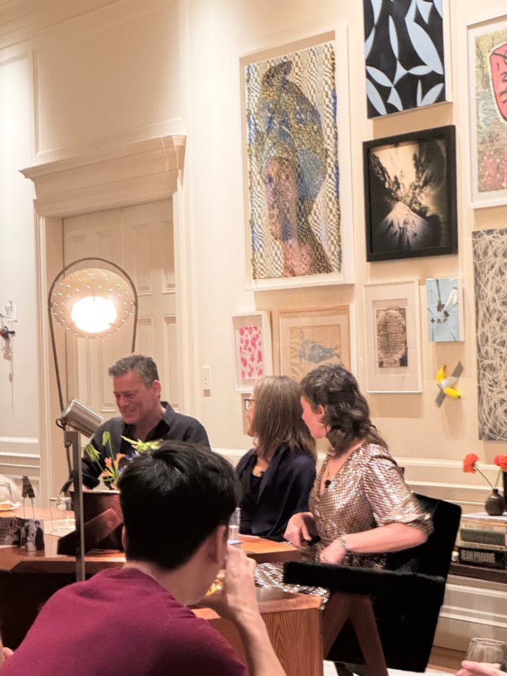 A living room filled with people and three people presenting