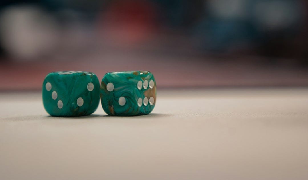 Two green dices sitting on top of a table Two green dices sitting on top of a table