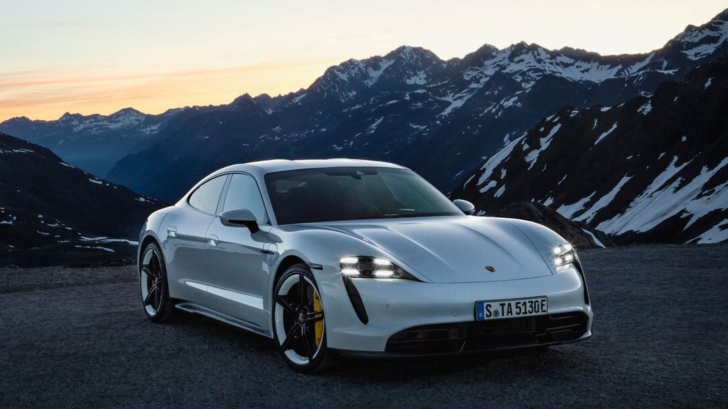 A white Porsche Taycan Turbo S on a mountain road