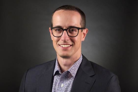 A person wearing glasses and a suit

AI-generated content may be incorrect.