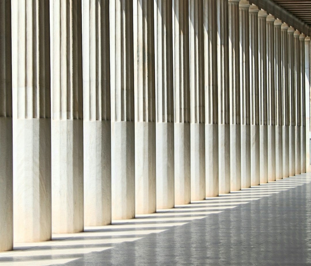 inline white concrete pillars with empty hallway inline white concrete pillars with empty hallway