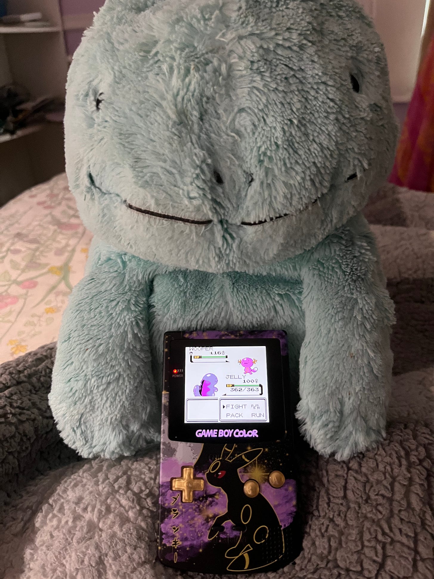 Ayano's favourite Pokémon is Quagsire, and she has a well loved plush of one called Jelly! Also pictured is a custom Game Boy Color with backlight, featuring Umbreon on the shell Ayano's favourite Pokémon is Quagsire, and she has a well loved plush of one called Jelly! Also pictured is a custom Game Boy Color with backlight, featuring Umbreon on the shell