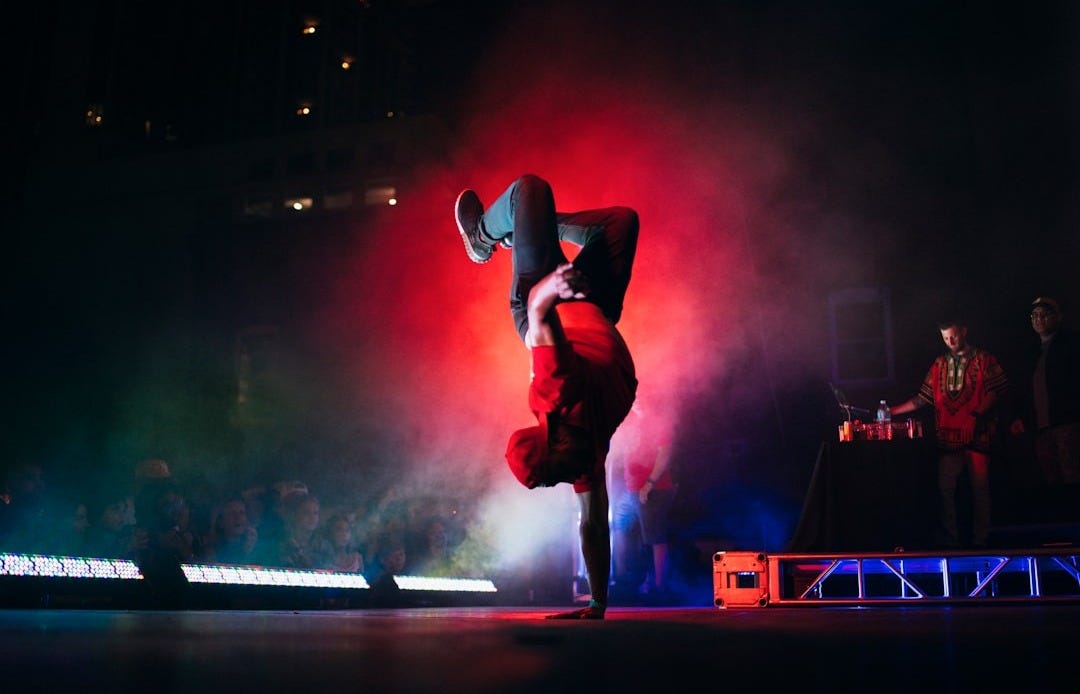 man doing breakdancing on gray surface
