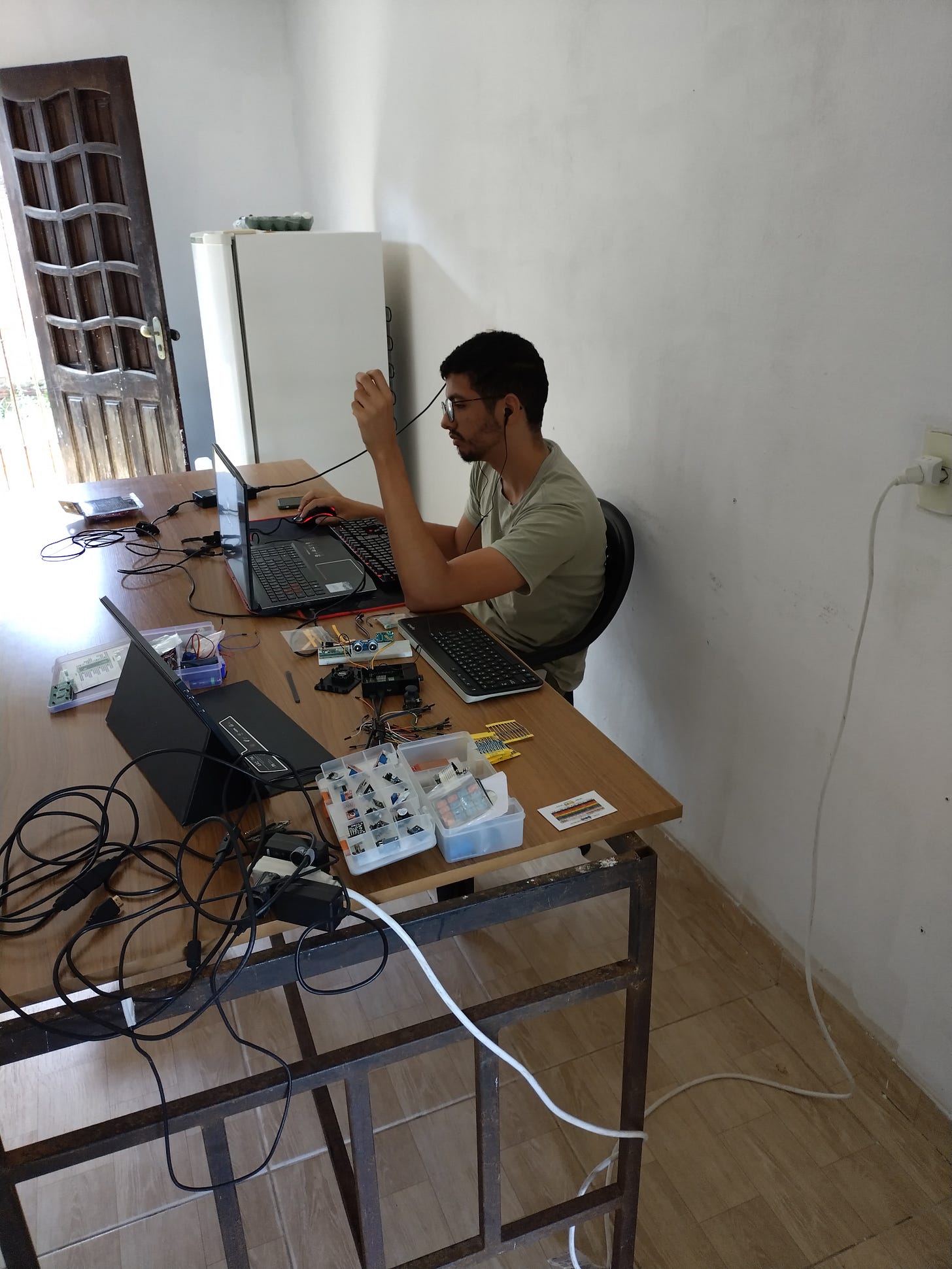 Ricardo working on his computer and electronic components