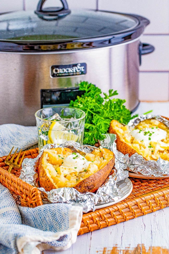 Slow Cooker Baked Potatoes - Learn how to make soft, fluffy, tender potatoes with super delicious skin in your slow cooker! Use this method when you want to free up oven space for a holiday meal or when you don't want to turn your oven on and heat up your house. Foolproof, perfect potatoes every time! 