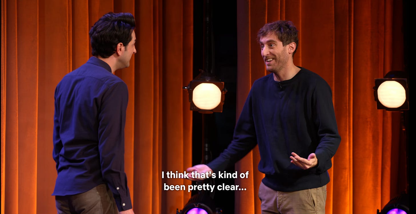 a screenshot of ben schwartz and thomas middleditch in conversation on stage, with middleditch saying "i think that's been pretty clear"