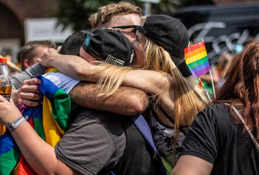 people hugging each other in the middle of crowd people hugging each other in the middle of crowd