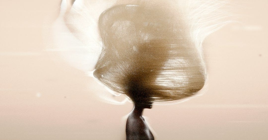 A person walking with a large object on their head