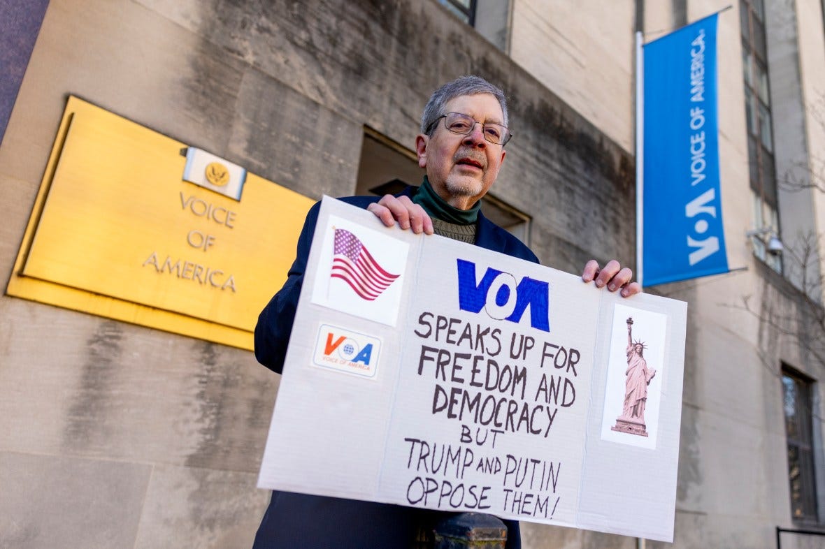 Protestor holding sign against dismantling of Voice of America. Protestor holding sign against dismantling of Voice of America.