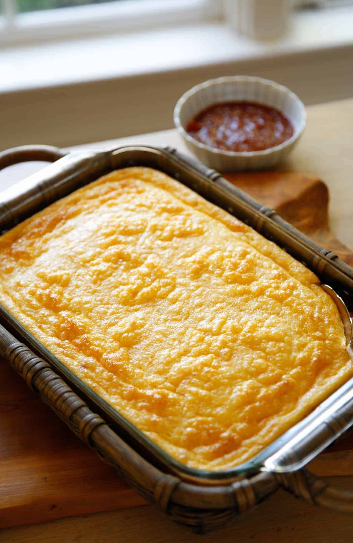 A fully baked Puffy Egg Bake casserole in basket cozy A fully baked Puffy Egg Bake casserole in basket cozy