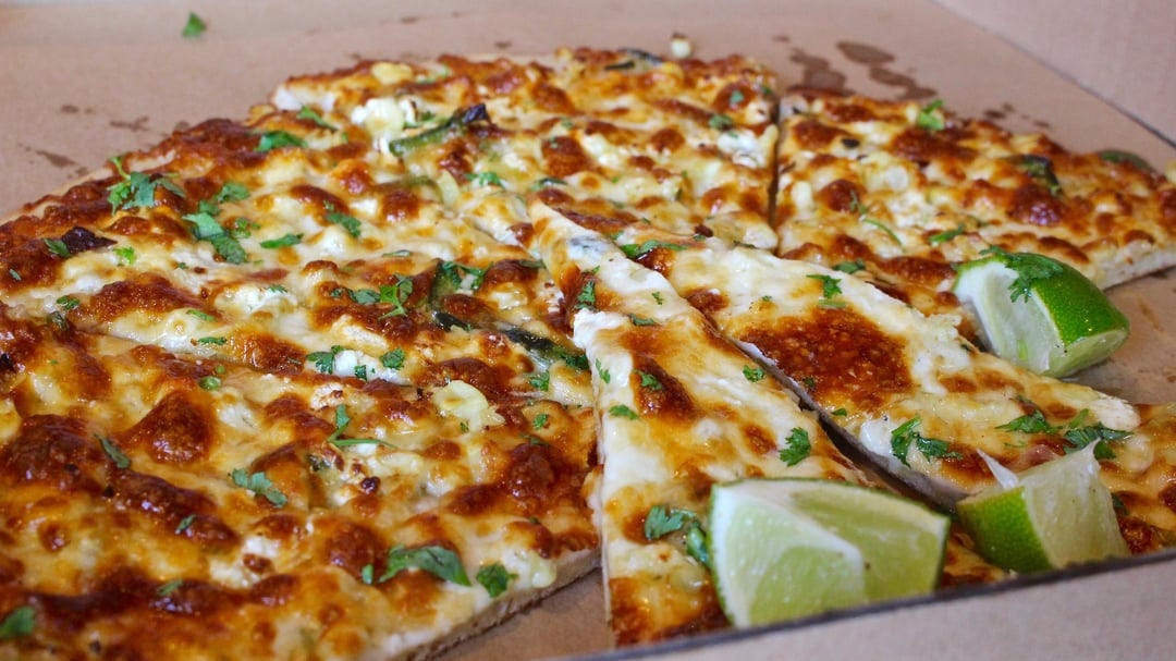Cheese Board Pizzeria is always worth the long wait in line (today's pizza:  corn, pasilla, onions, mozzarella, feta, cilantro, lime) : r/Pizza