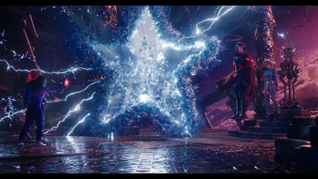 America Chavez opens a glowing, star-shaped portal as Doctor Strange and Christine Palmer watch in Doctor Strange in the Multiverse of Madness.