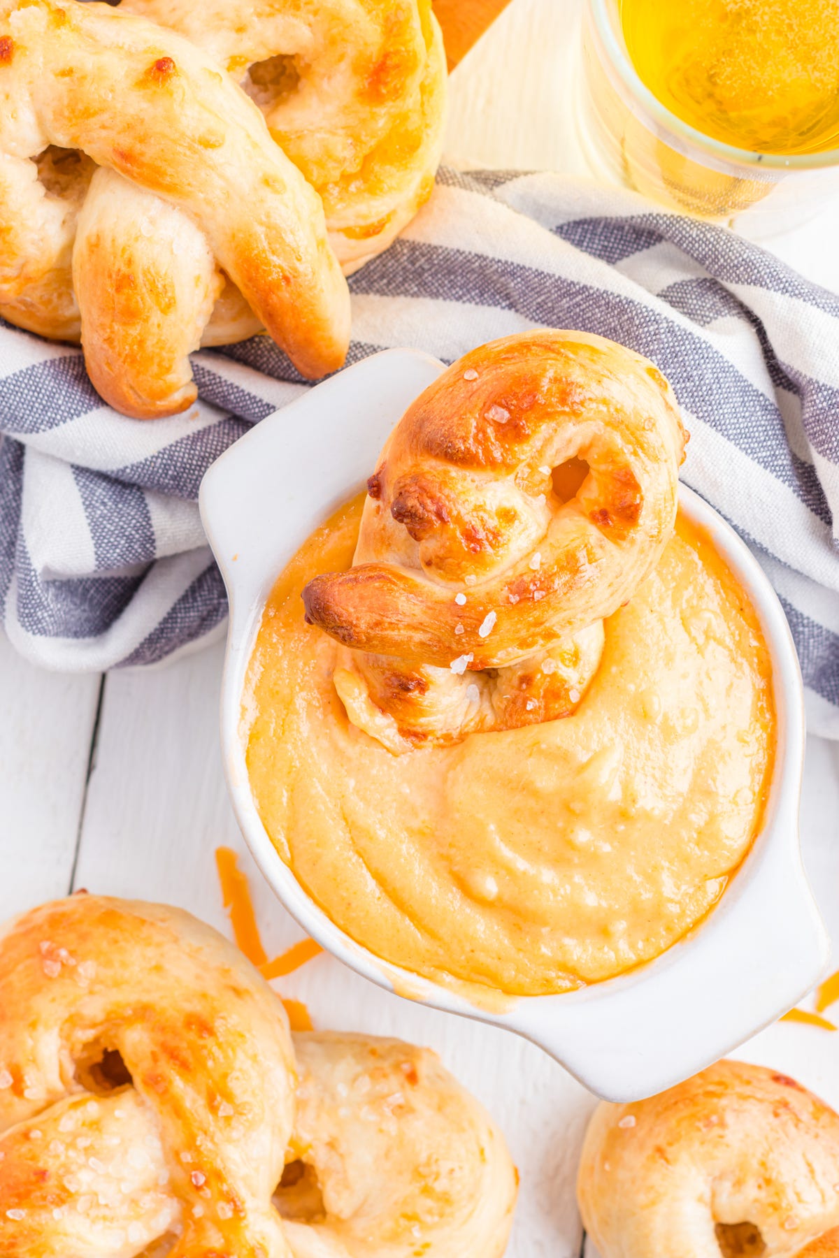 Pretzel Beer cheese dip in a bowl, with pretzel dipped in. Pretzel Beer cheese dip in a bowl, with pretzel dipped in.