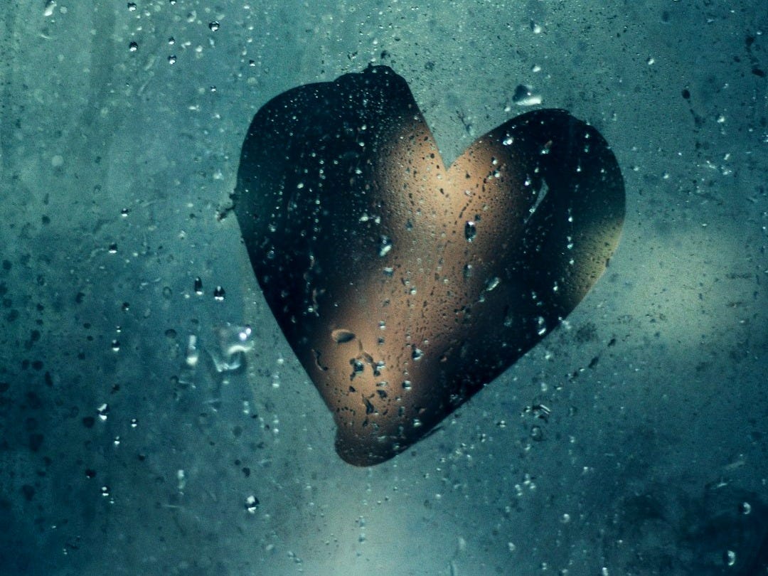 moist glass wall with heart drawing