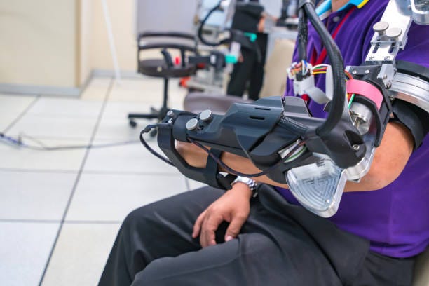 man wear robot arm for physical therapy. By defining how a robot driven moving technique can be improved to achieve better results in physical rehabilitation man wear robot arm for physical therapy. By defining how a robot driven moving technique can be improved to achieve better results in physical rehabilitation. robotic rehabilitation stock pictures, royalty-free photos & images