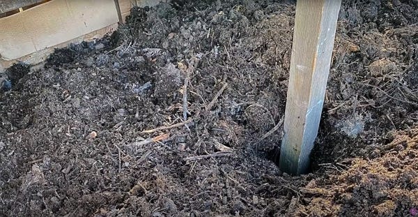 A wood post on the middle of a heap A wood post on the middle of a heap