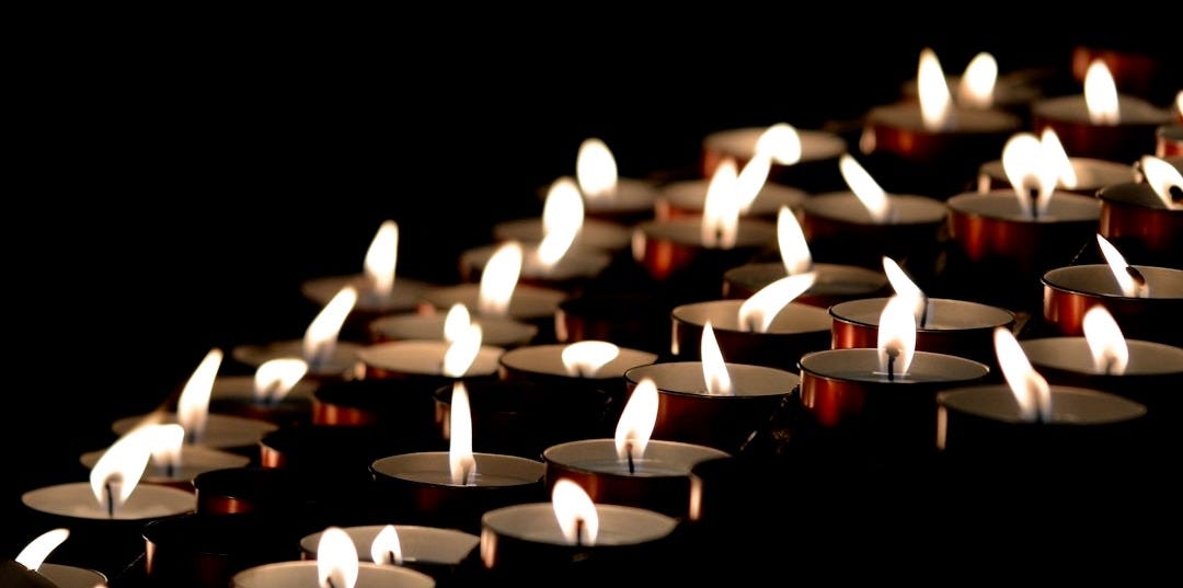 white candles on black surface