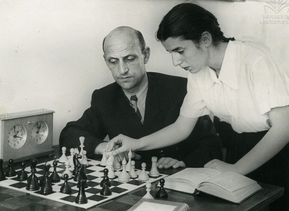 May be an image of 2 people, chess and text