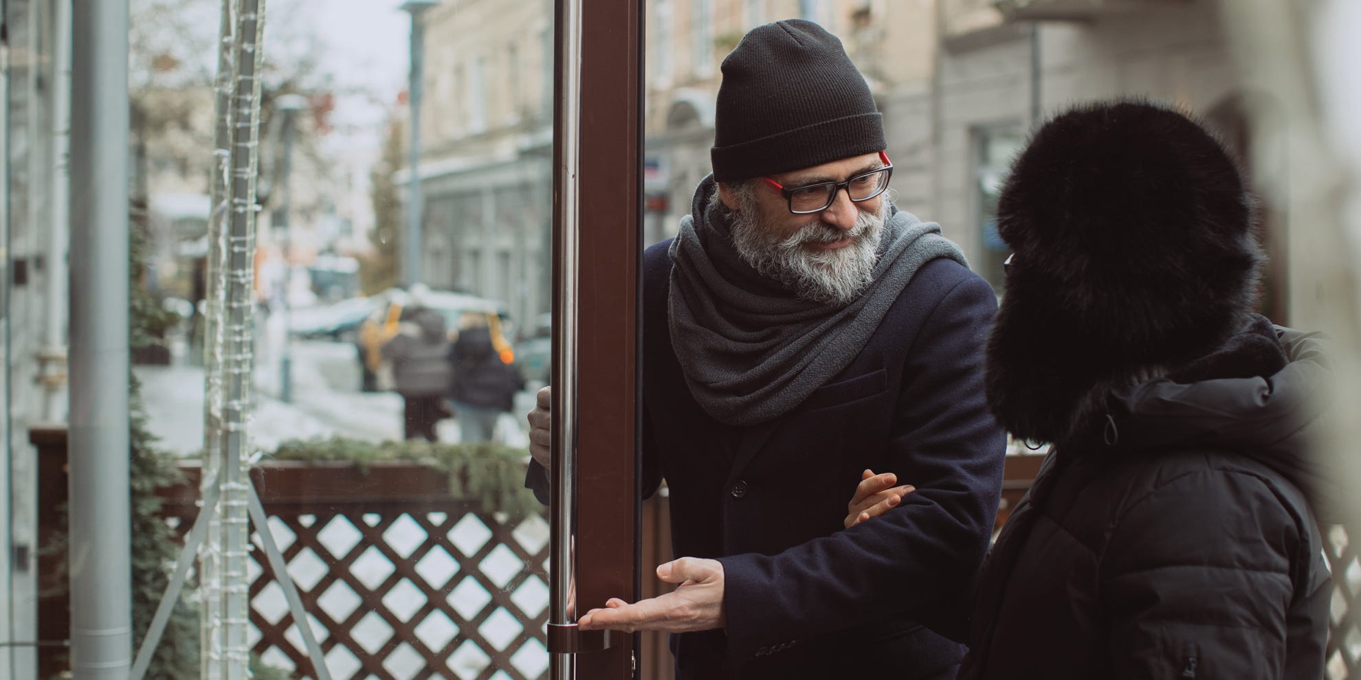 Man holding door for woman symbolizing writing symbolism Man holding door for woman symbolizing writing symbolism
