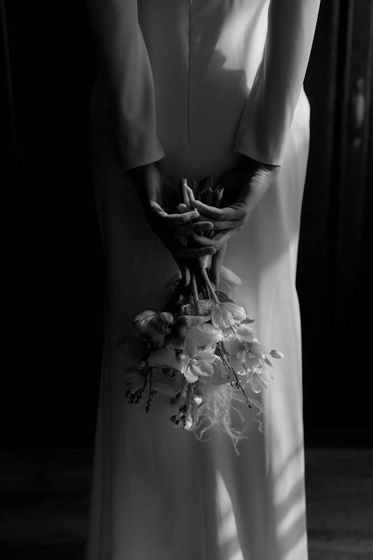 May be a black-and-white image of flower and wedding May be a black-and-white image of flower and wedding
