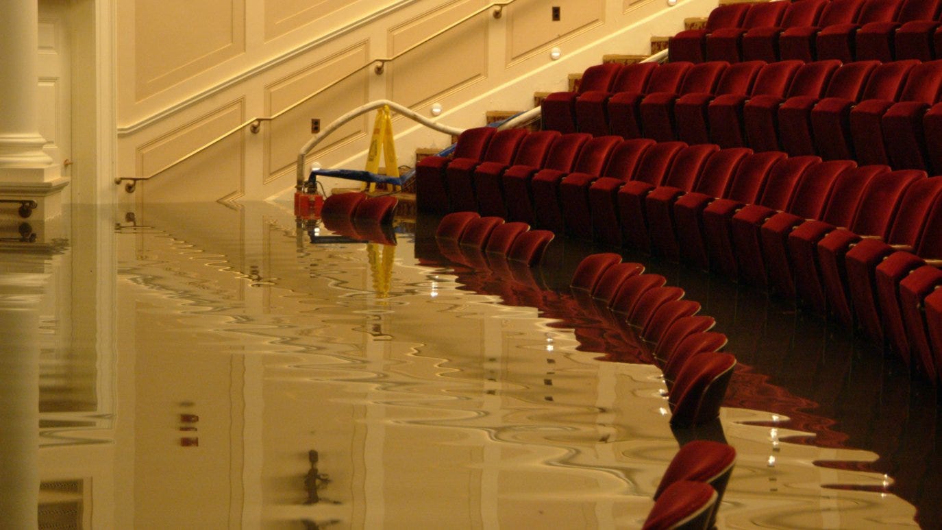 https://media.nbcwashington.com/2019/09/McGowan-Theater-with-water-6-26-06-Photo-by-Jeffrey-Reed-for-the-National-Archives.jpg?quality=85&strip=all&fit=3024%2C2016&w=1375&h=773&crop=1